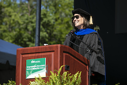 Dean Germaine Louis addresses 2021 and 2020 graduating classes during the in-person celebration.