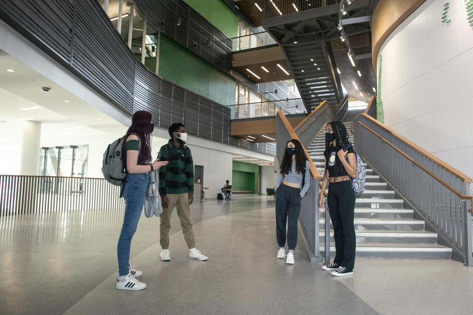 Four students standing together in Horizon hall 